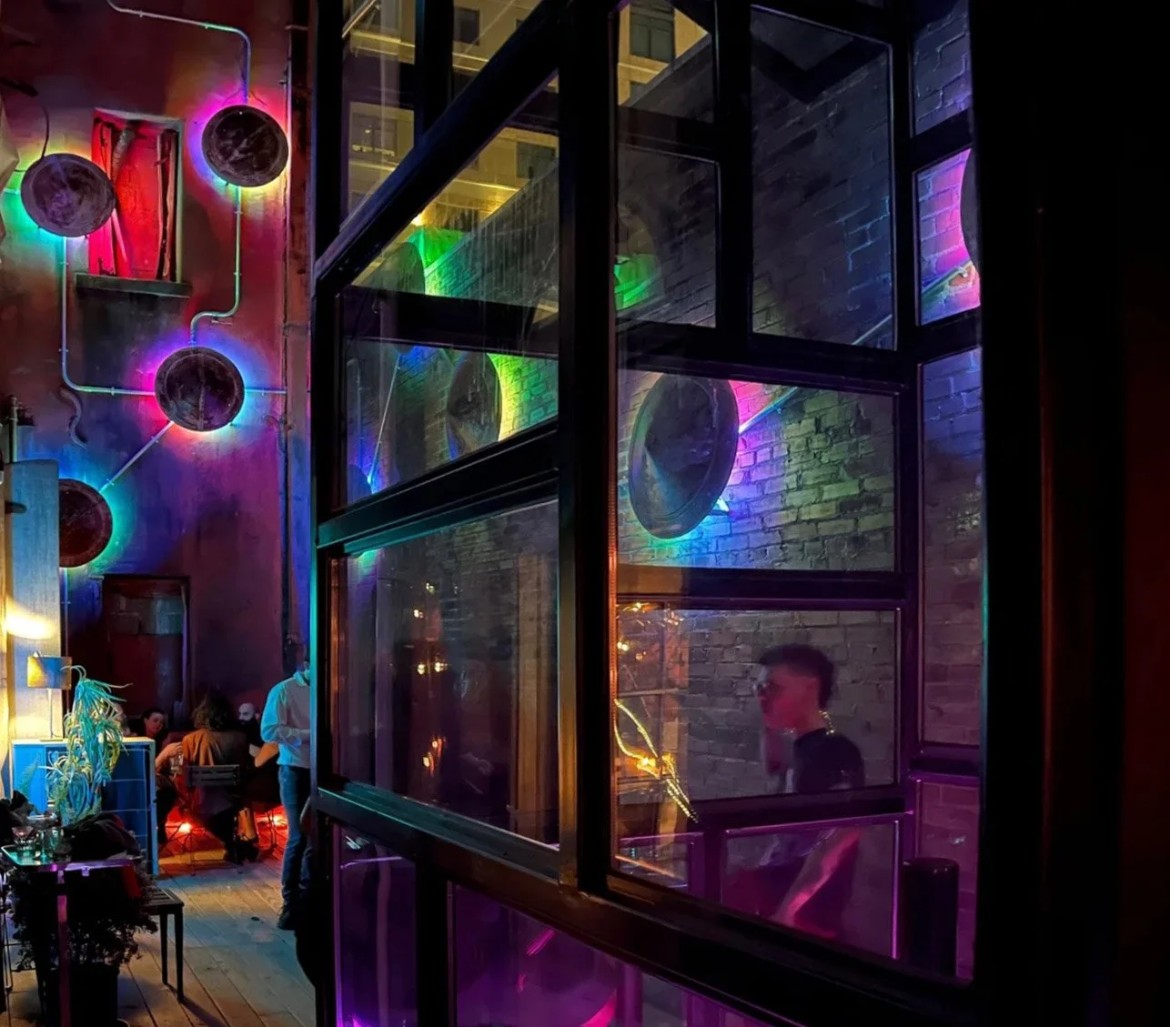Patio with illuminated wall sculpture.