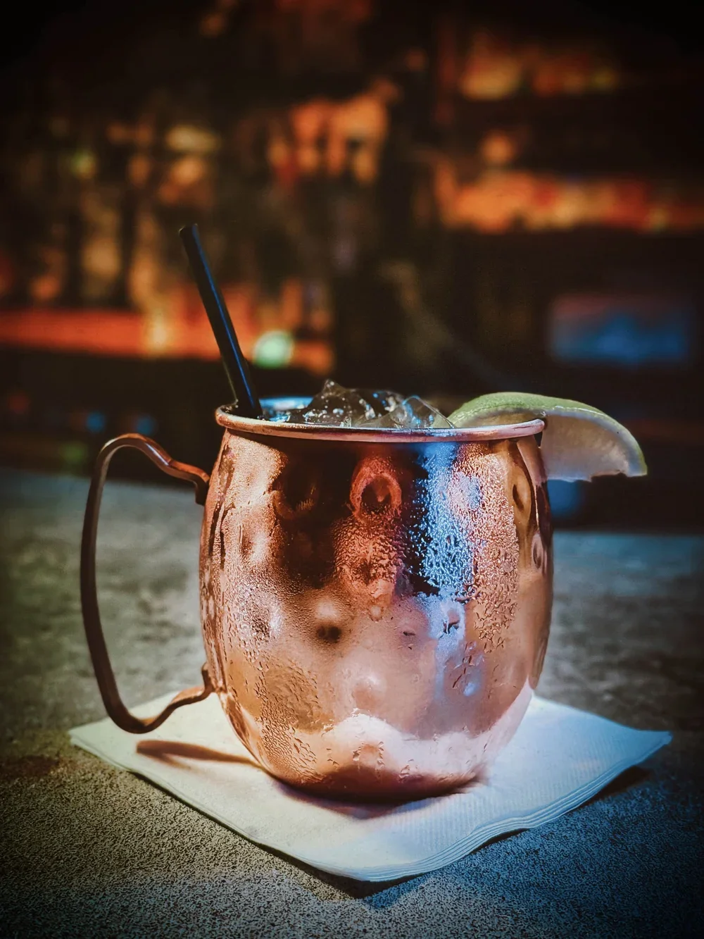 cocktail in a copper mule cup with a lime