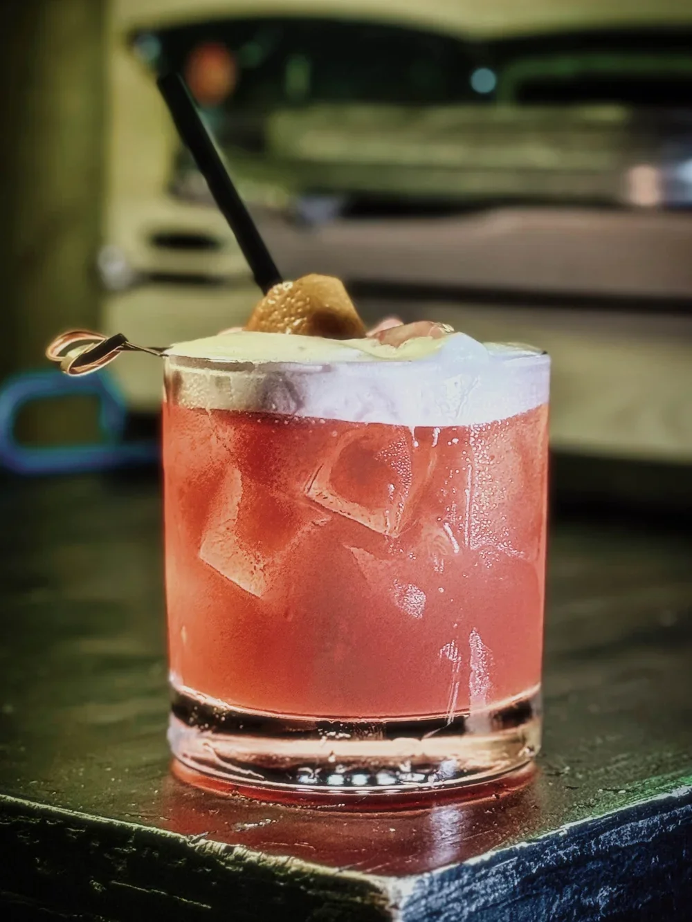 Whiskey cocktail with a foam on top.