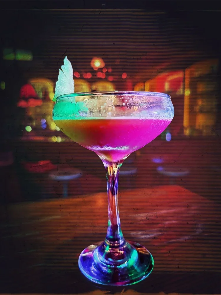 Brightly colors cocktail with garnish