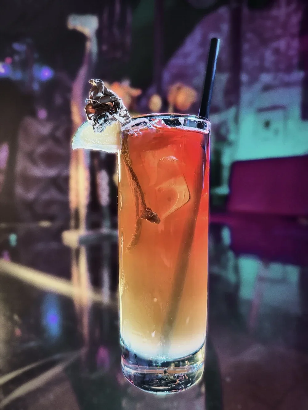 Cocktail in a tall glass with garnish