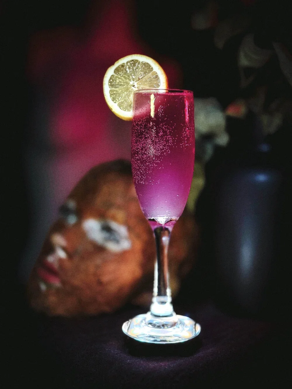 Purple Cocktail with lemon wedge
