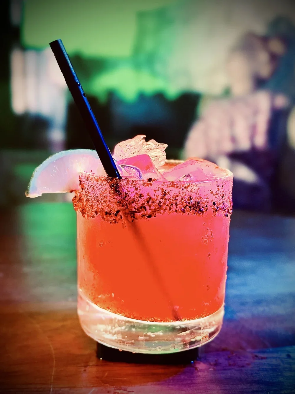 Bright pink margarita with garnish.