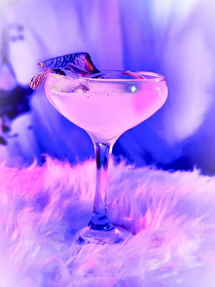 Gin cocktail with mint in a coupe glass.