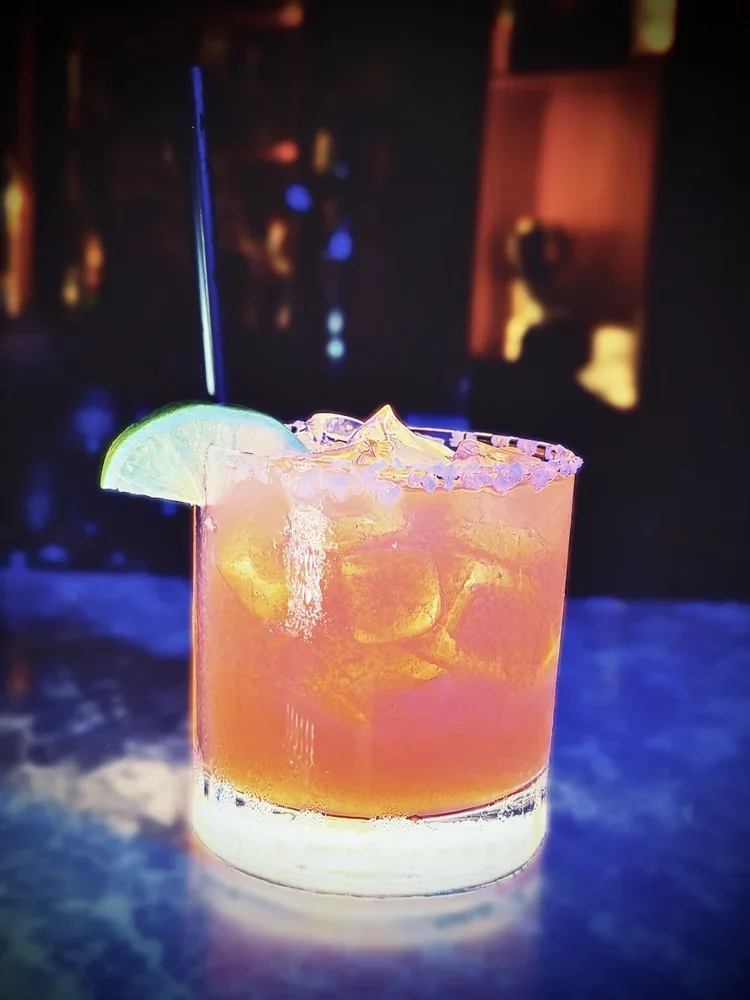 Strawberry Margarita with a lime wedge