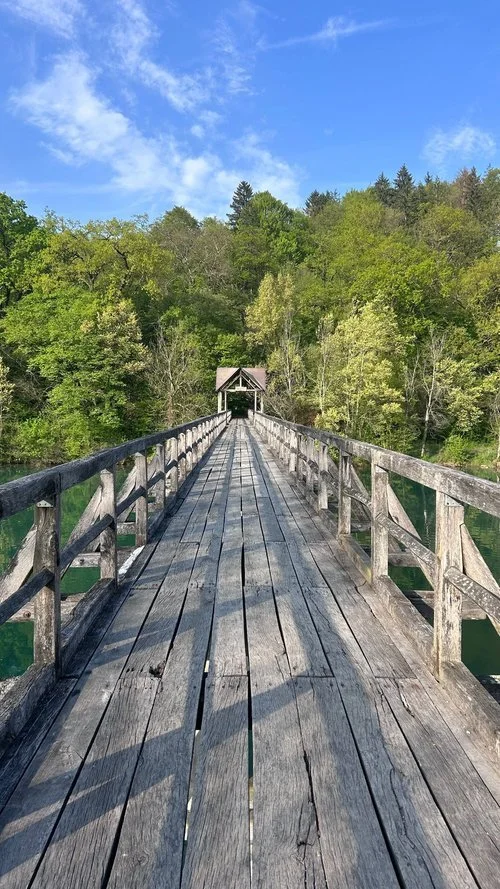 historic wooden footbridge over river.jpg
