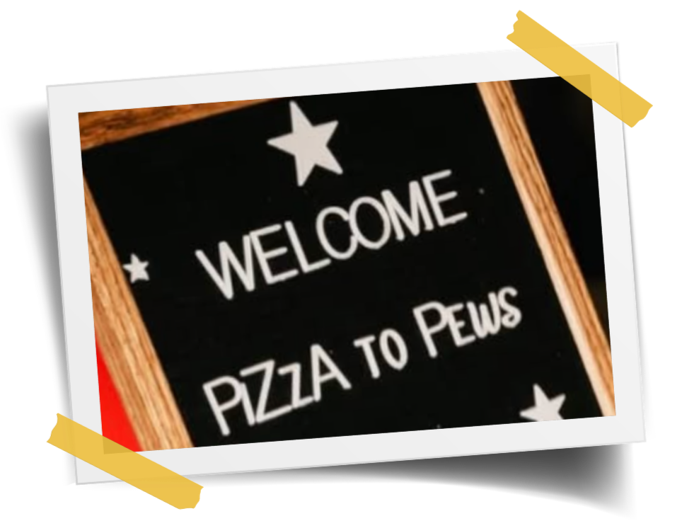 A blackboard sign with a wooden frame that says "Welcome Pizza to Pews" surrounded by stars, taped to a surface with yellow tape.