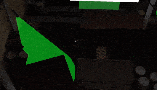 Table with a green paper airplane and scattered coins.