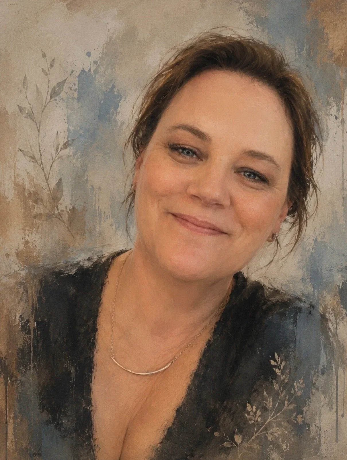 A woman with short brown hair and blue eyes, smiling, wearing a black top and a delicate gold necklace, standing against a textured wall with a plant design.