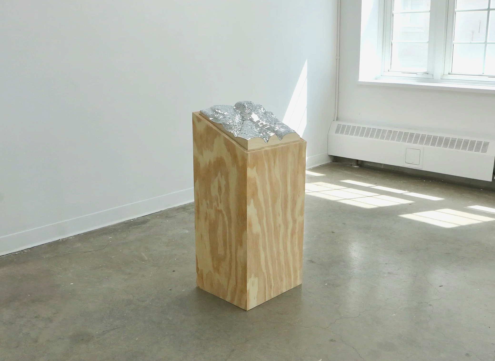 
Orientations 1, 2026 
12 x 13 x 32 inches

Plywood, solid pine carved map, glass mirrored tiles
