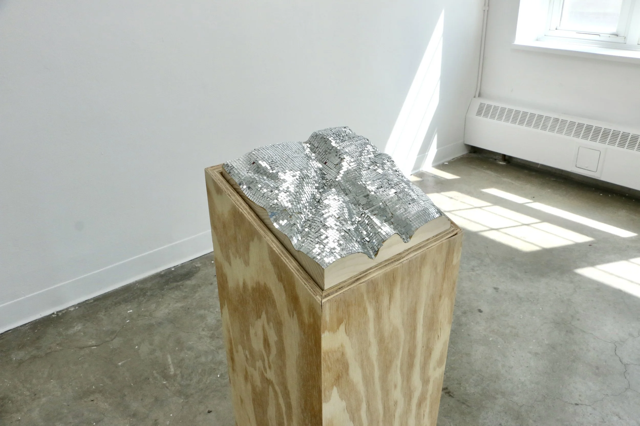 
Orientations 1, 2026 
12 x 13 x 32 inches

Plywood, solid pine carved map, glass mirrored tiles
