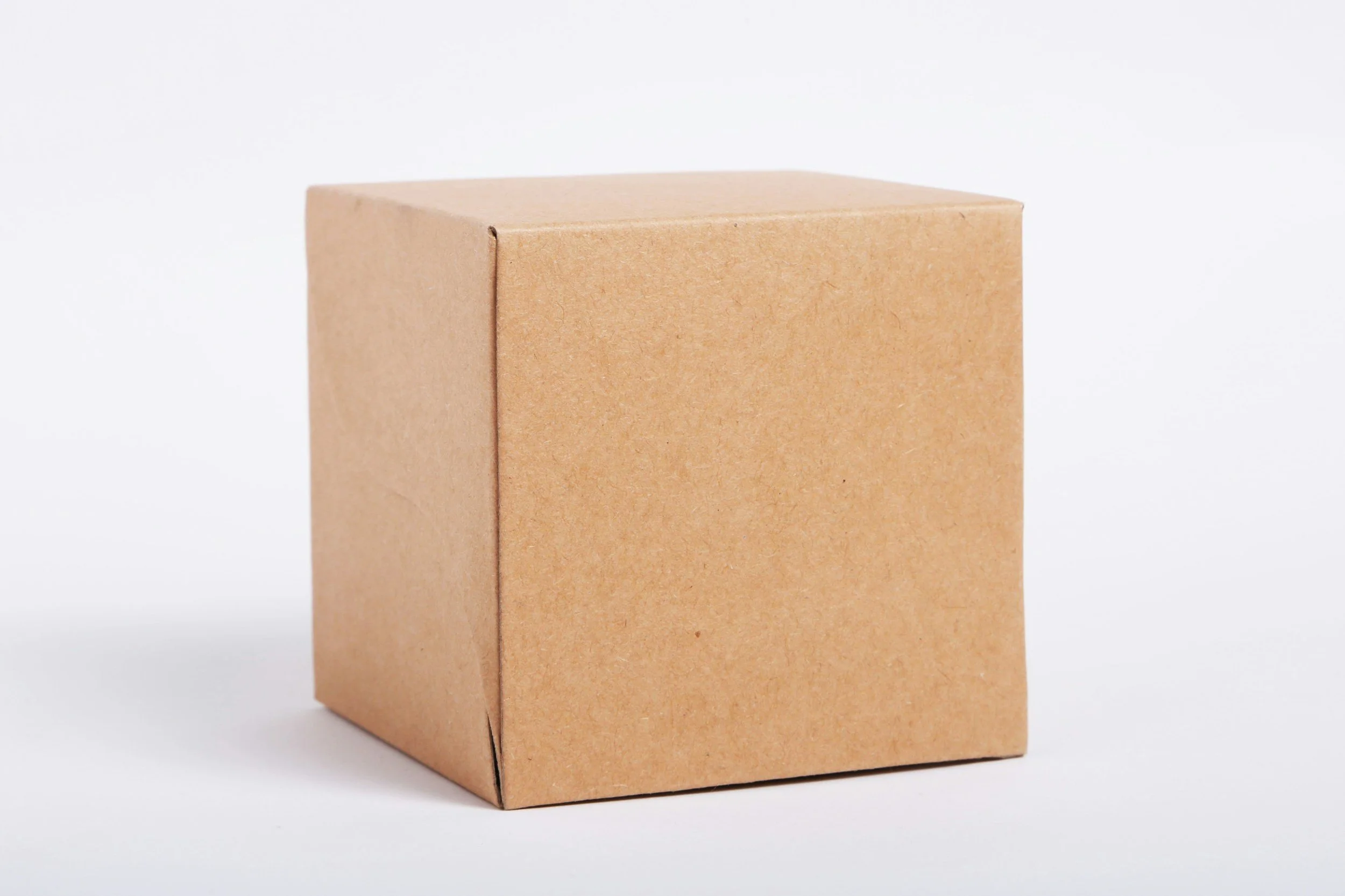 A plain brown cardboard box with a seam on the side, set against a white background.
