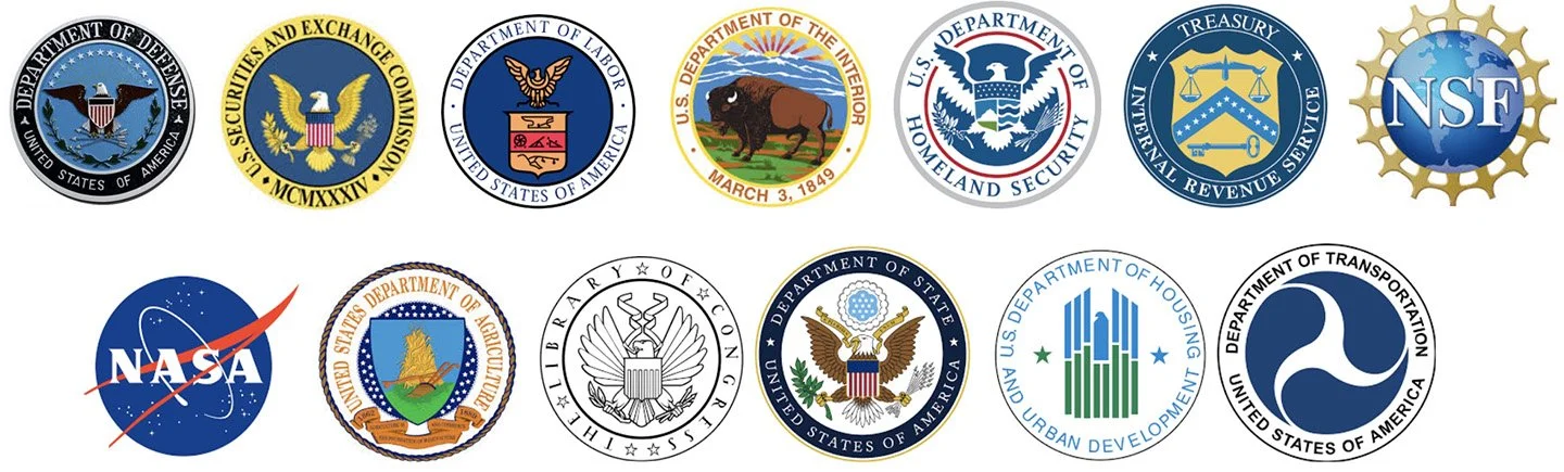 Collection of circular logos of various U.S. government agencies, including Defense, Securities and Exchange Commission, Labor, Interior, Homeland Security, Treasury, NSF, NASA, Agriculture, Coast Guard, State, Housing and Urban Development, and Transportation.