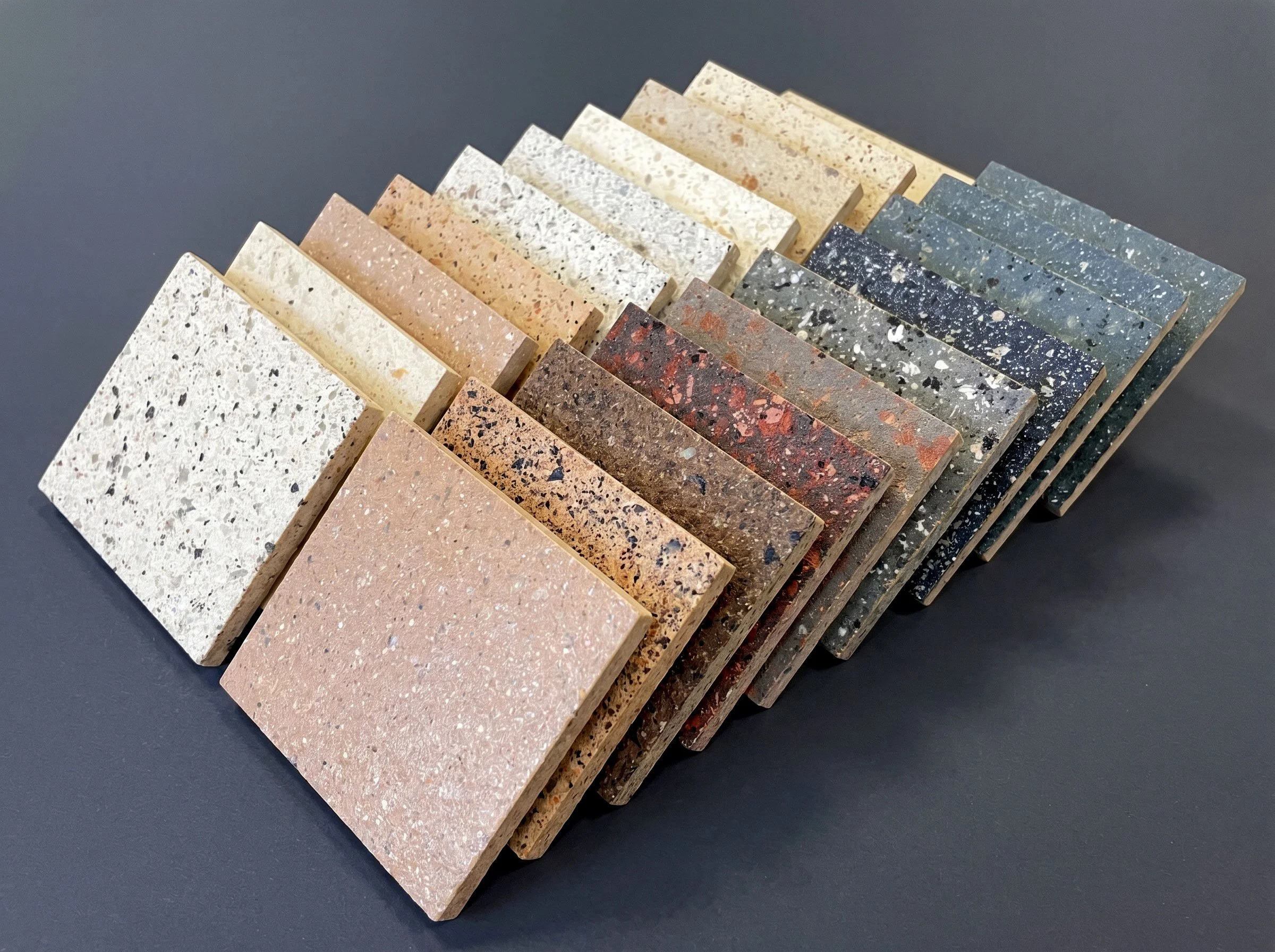 Sample of various textured and colored granite slabs arranged in a fan shape.