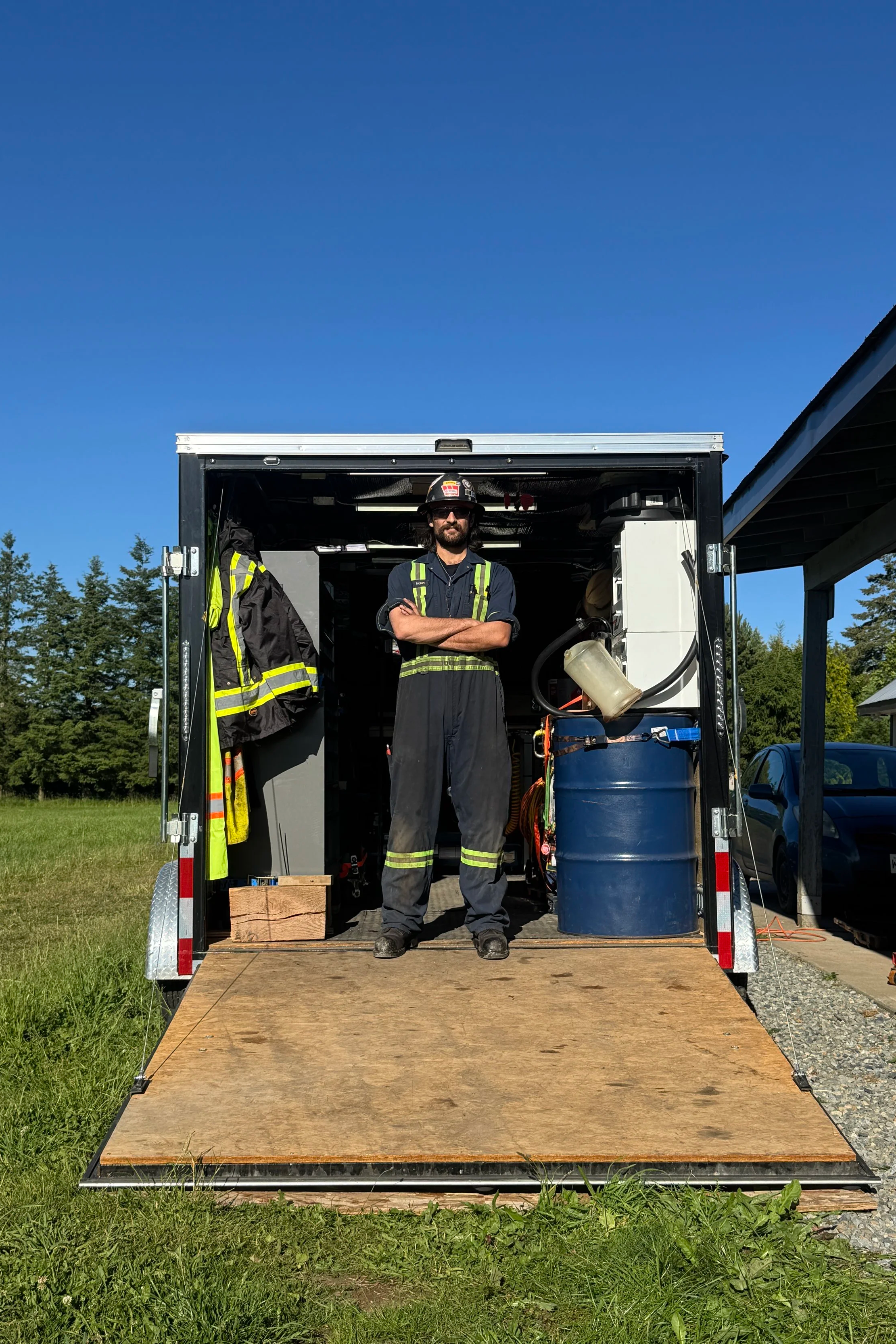 mobile equipment mechanic stands in his work trailer on a nice, sunny day