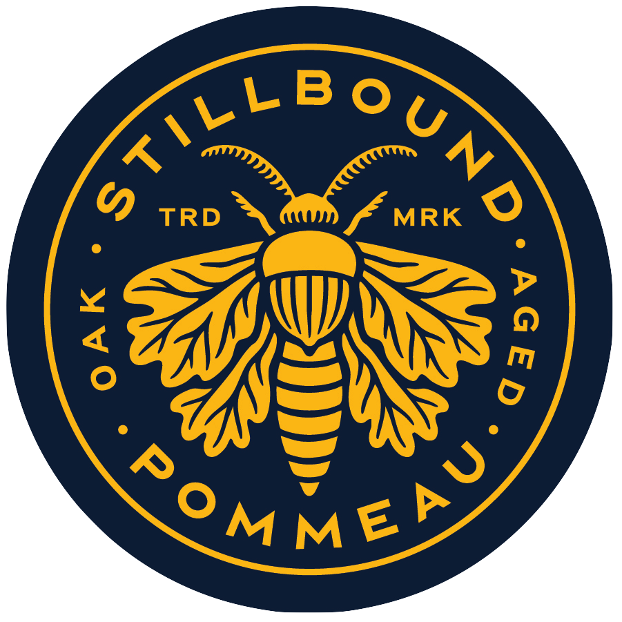 A circular logo with a dark blue background and yellow elements. It features a detailed illustration of a bee with outstretched wings in the center. Around the bee, the text reads "STILLBOUND A G D POMMEAU" with "TRD" and "MRK" on either side of the bee.