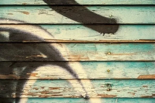 spray painting on blue wood