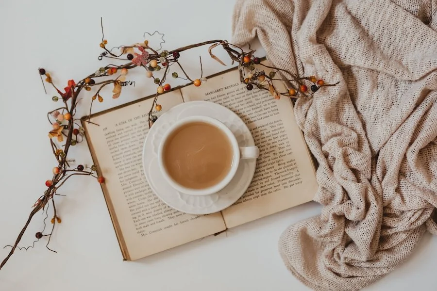 coffee mug on top of a book