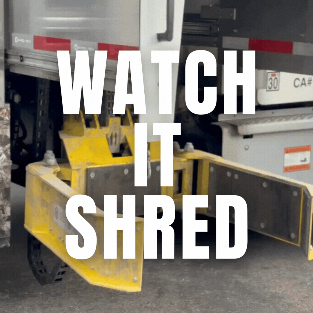 A yellow street sweeper attachment in front of a truck near a brick wall with overlaid text that reads 'WATCH IT SHRED'.