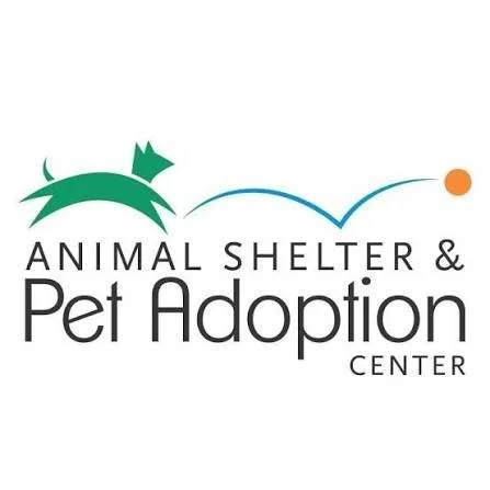 Logo for Animal Shelter & Pet Adoption Center featuring a green dog, a blue line, and an orange ball above the text.