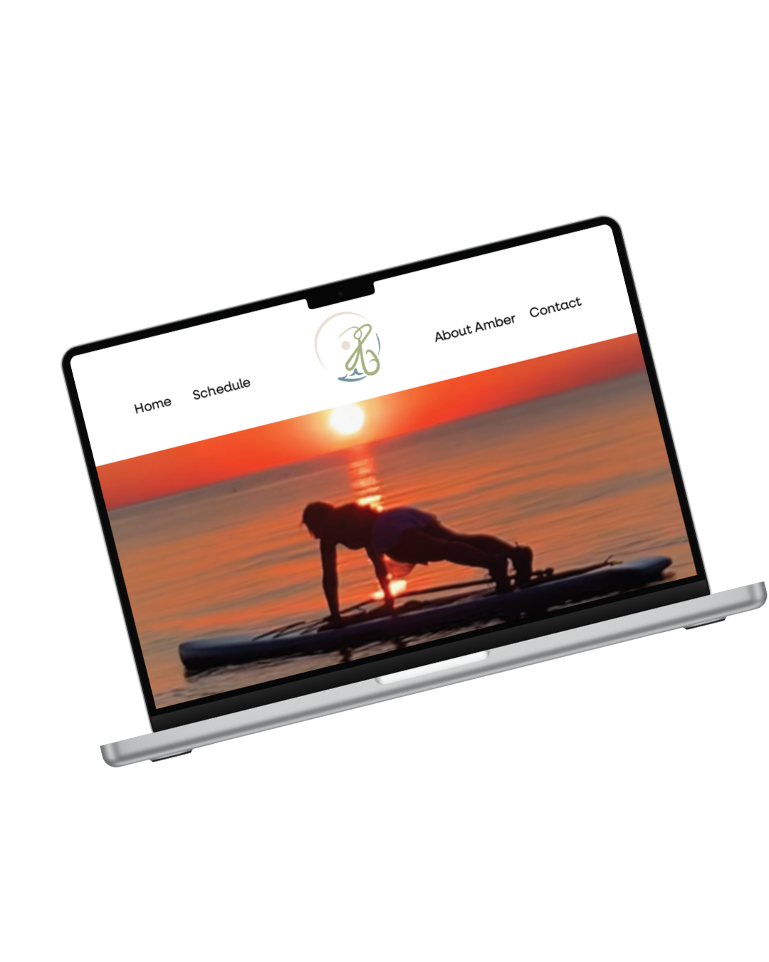 A laptop displaying a website with a background of a person doing yoga on a paddleboard during sunset at the beach, with a logo and menu options for Home, Schedule, About Amber, and Contact.