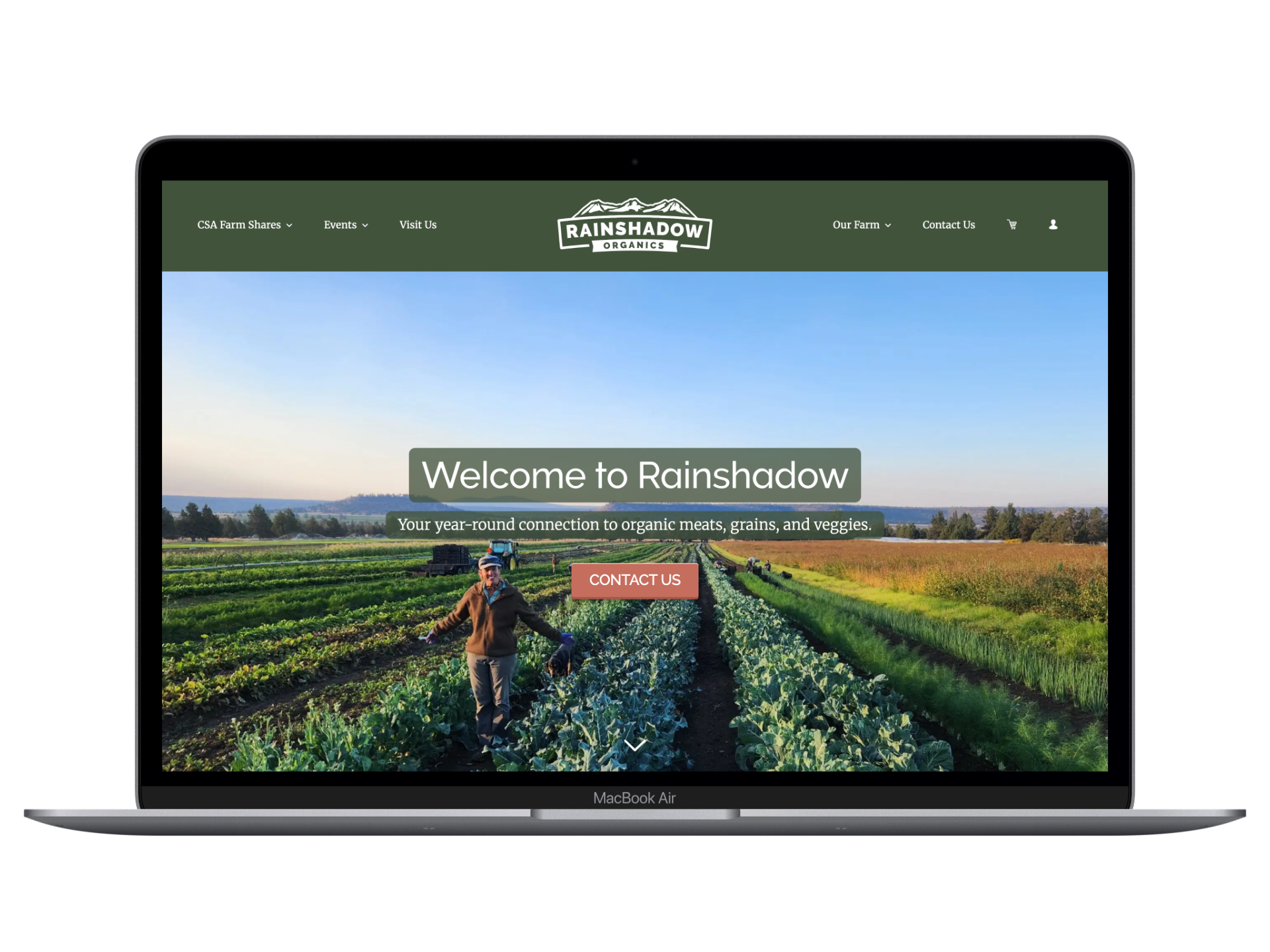 Homepage of Rainshadow Organics website showing a person with a dog in a lush green farm with crops, under a clear sky.