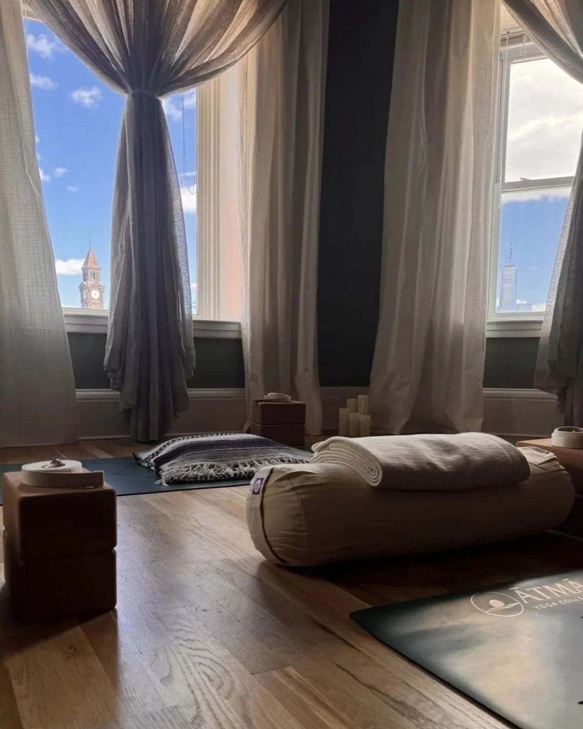 Quiet interior detail of ĀTMĀ Yoga Collective studio — naturally lit, simply designed space for practice