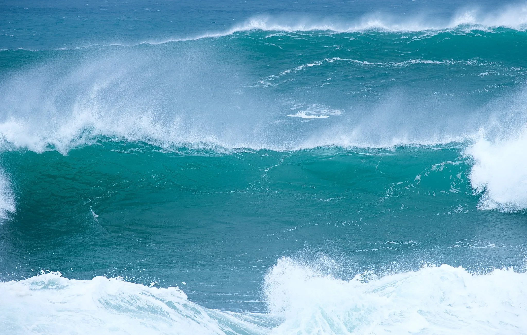 Image of ocean waves with white foam and turquoise water.
