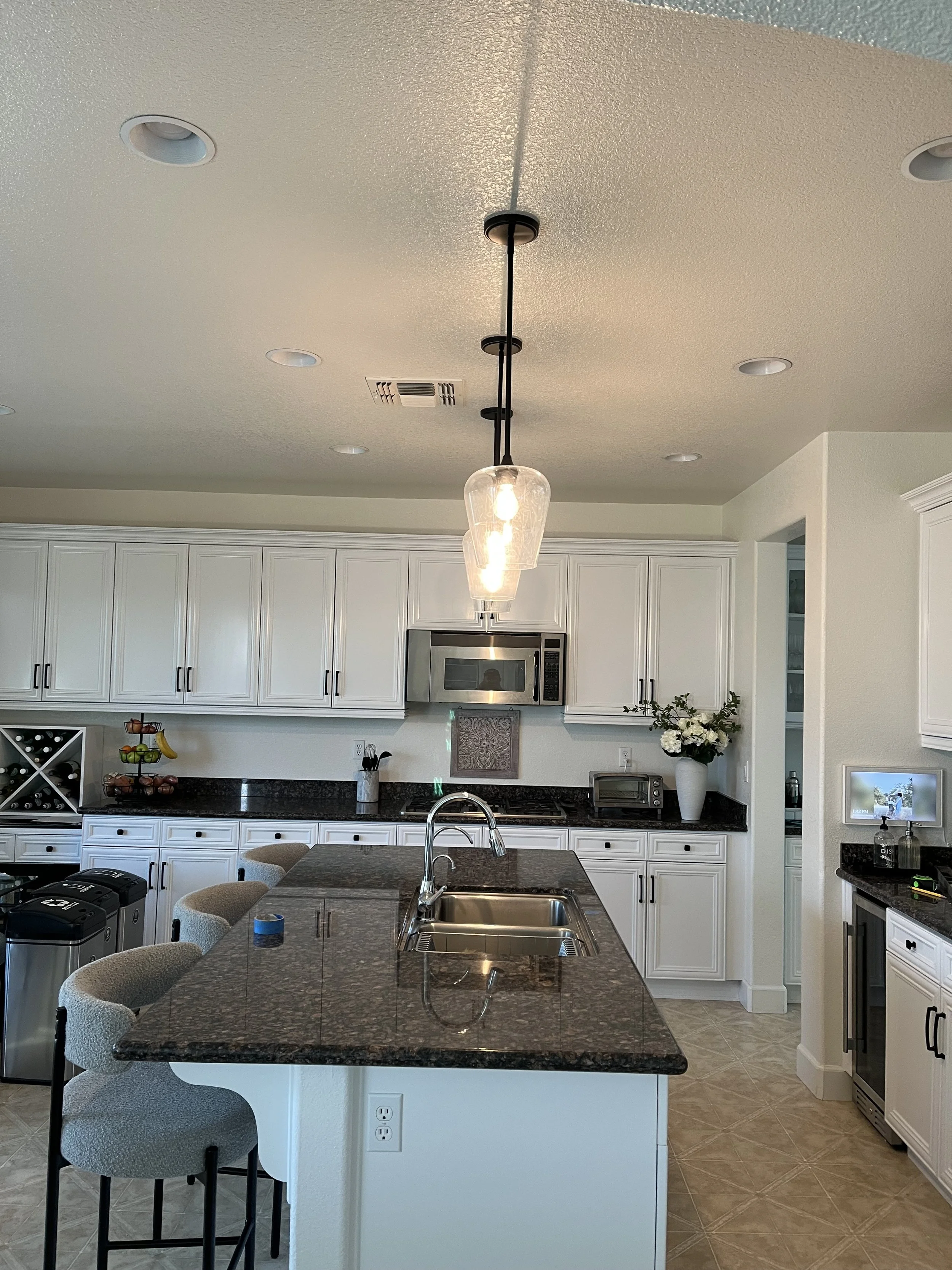 New hanging light fixture install over their kitchen island.