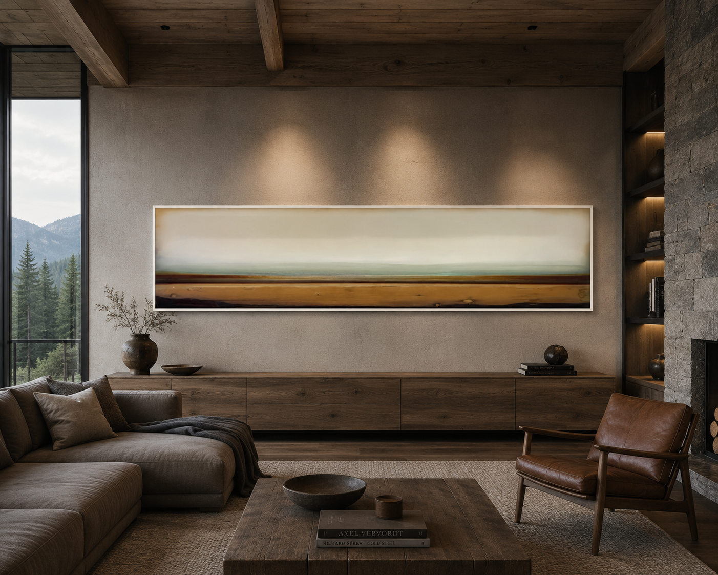 Living room with a beige sofa, leather armchair, wooden coffee table, large artwork, books, vases, and a mountain view outside