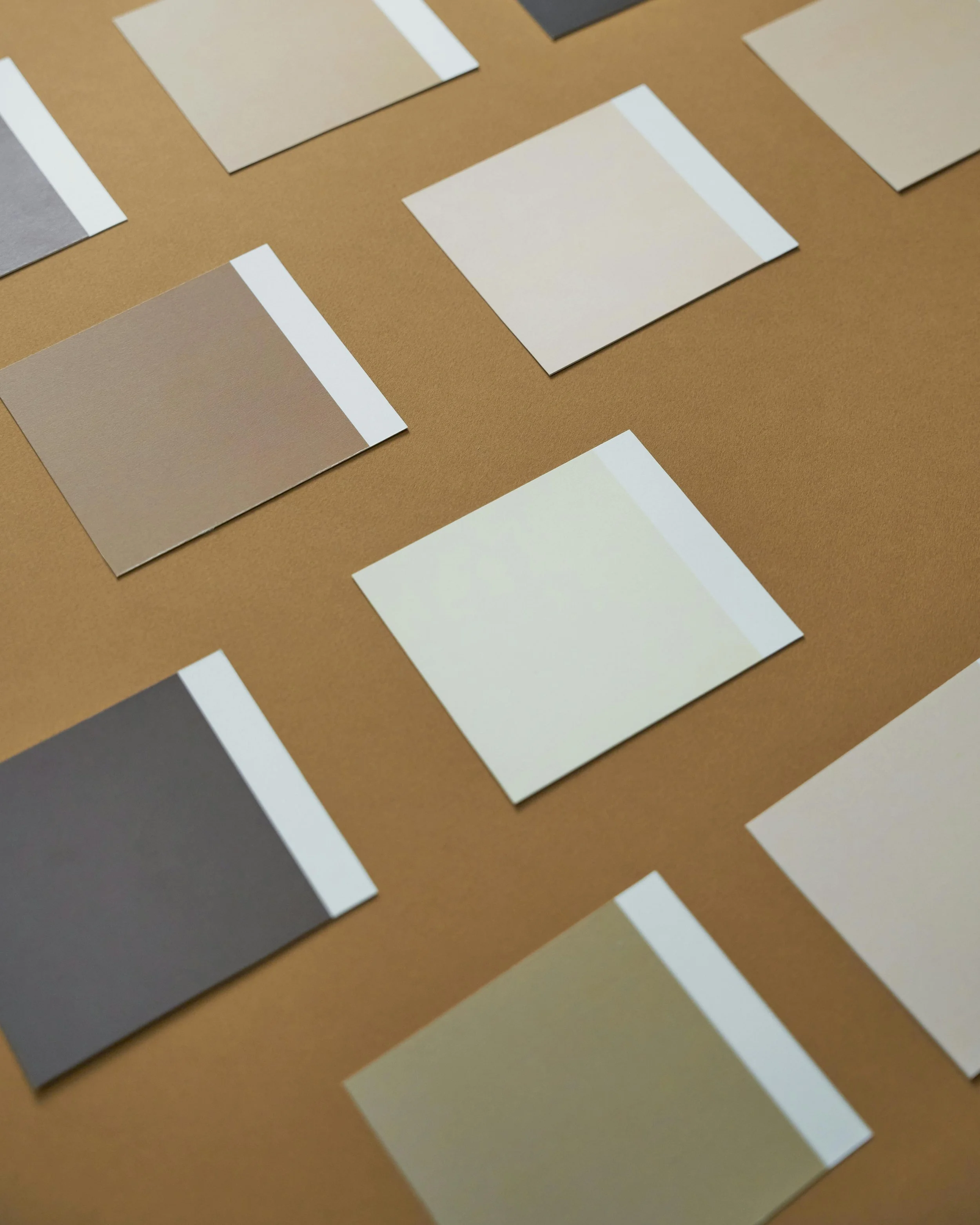 Assorted color sample swatches arranged on a surface.