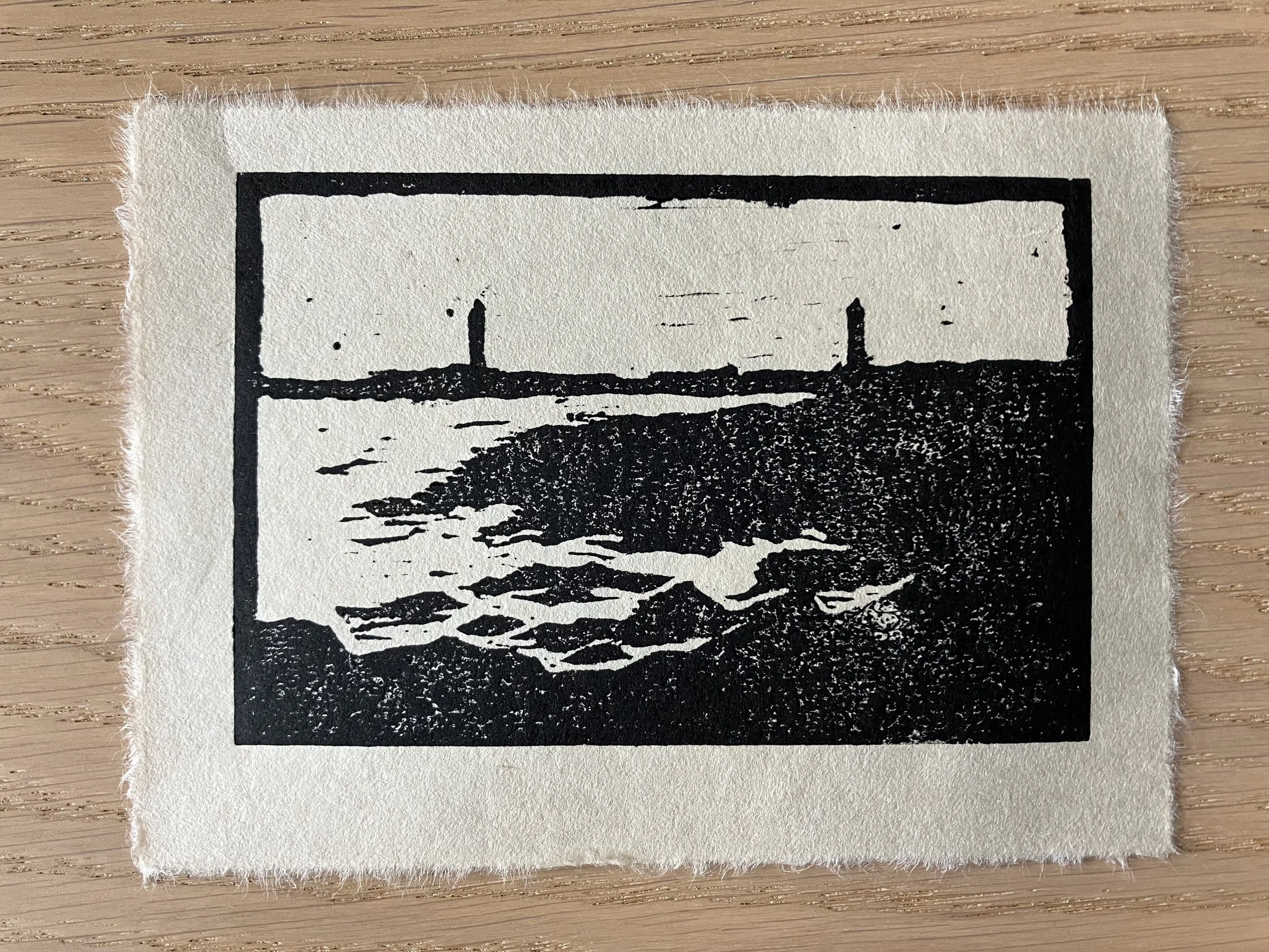 Black-and-white woodcut depicting the lighthouses of Thacher Island from Loblolly Cover in Rockport, Massachusetts.