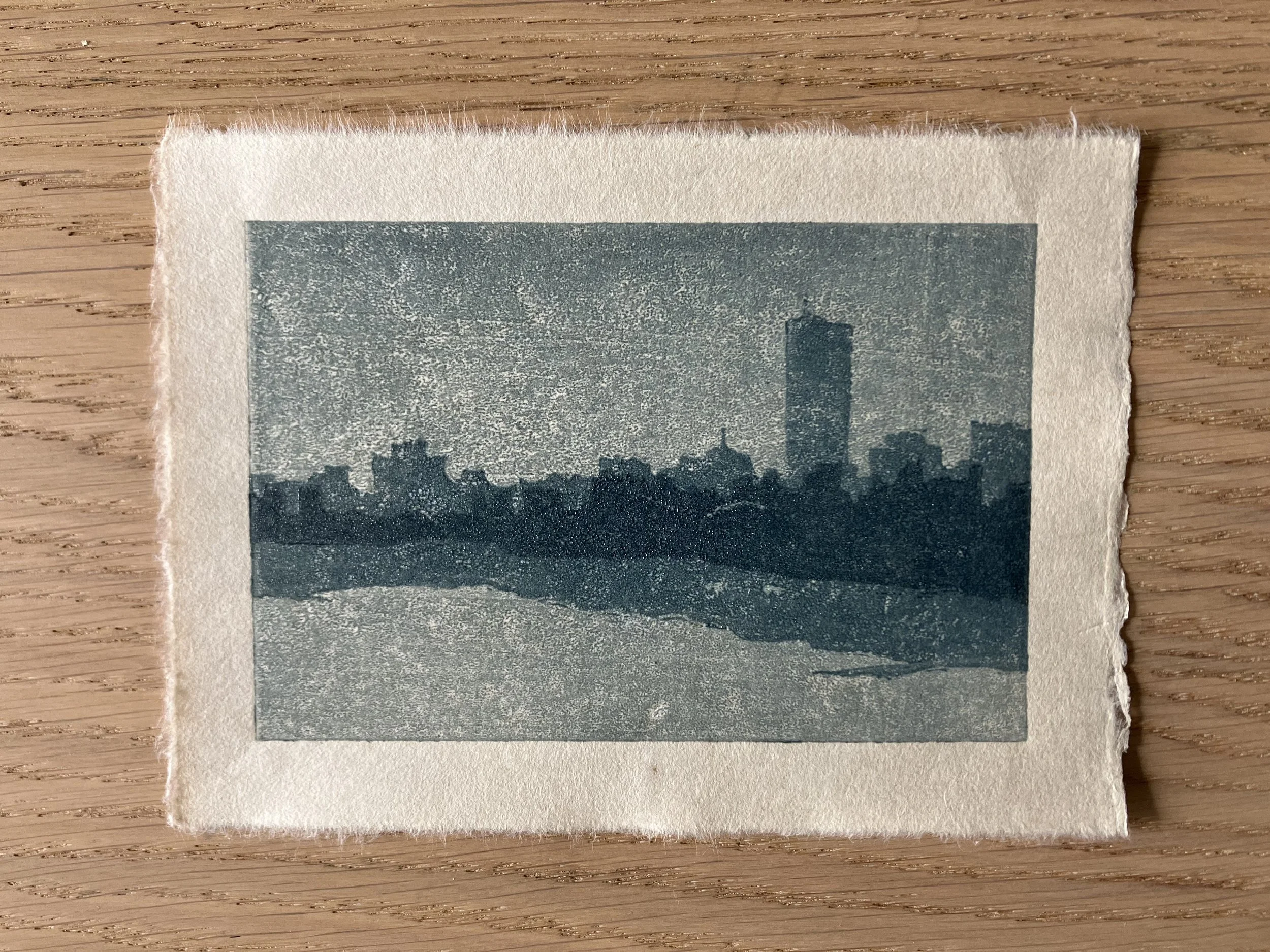 Woodcut print of a silhouetted Boston city skyline against a blue background.