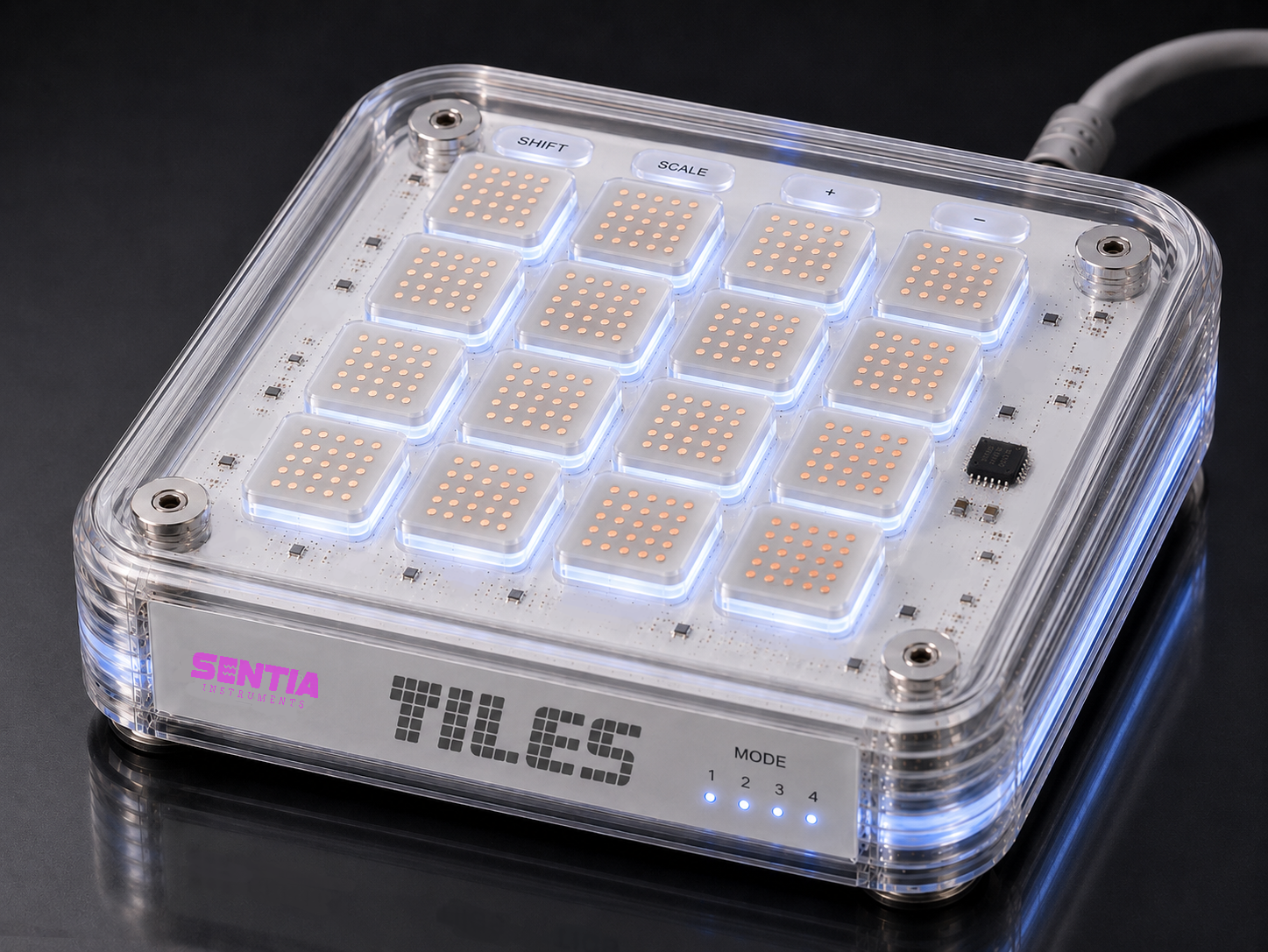 TILES Core MIDI controller with a transparent case, illuminated buttons, and a label that says 'SENTIA Instruments'.