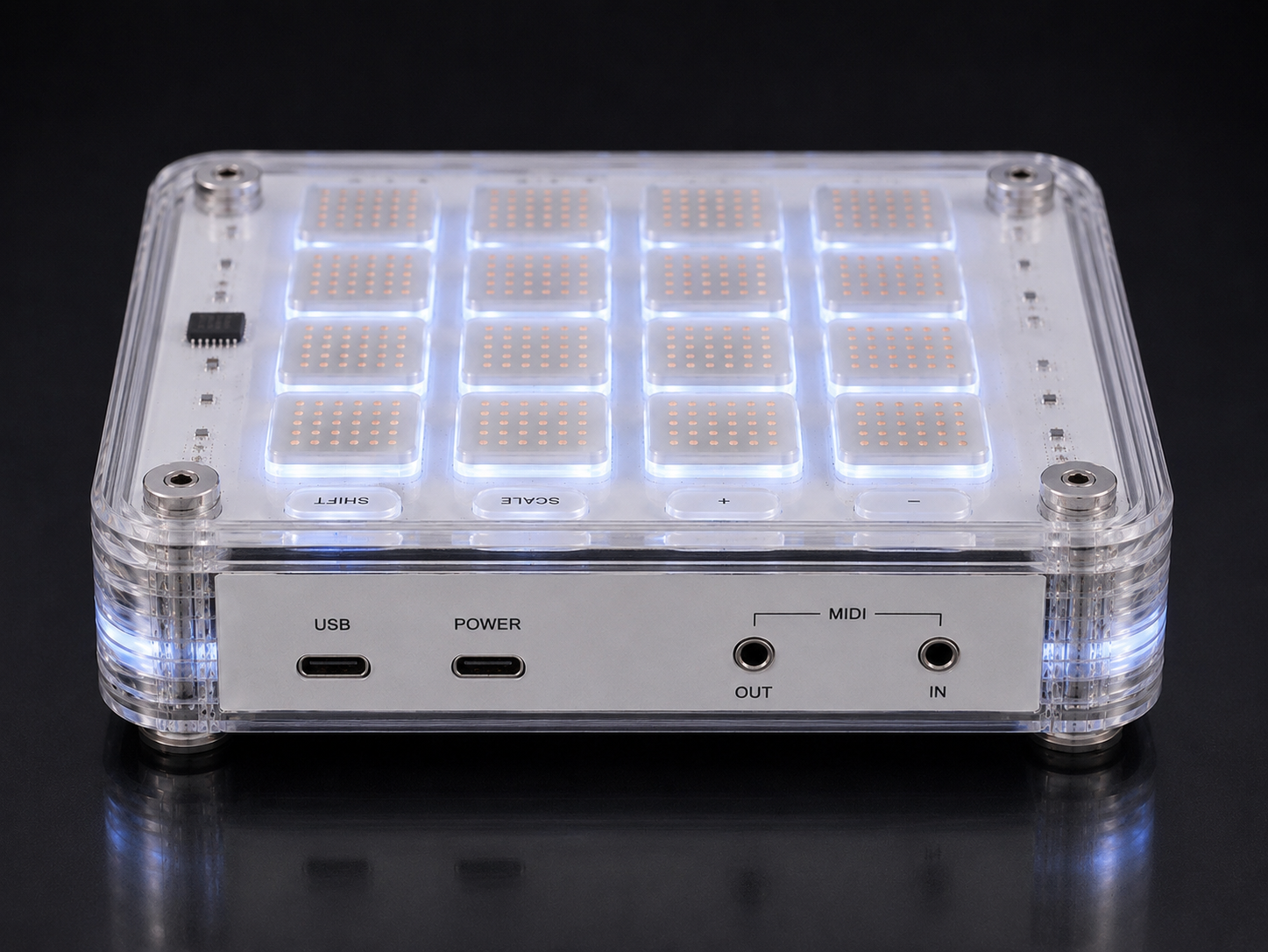 TILES Core MIDI controller with LEDs illuminating it, labeled buttons, and ports for USB, power, and MIDI connections, set against a black background.