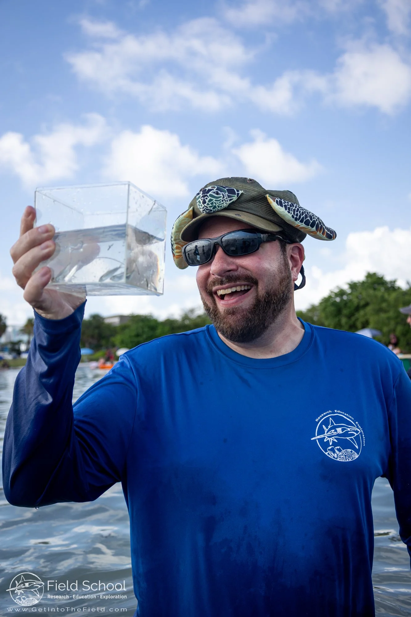 Dr. David Shiffman observing two silverside minnows caught during seine netting