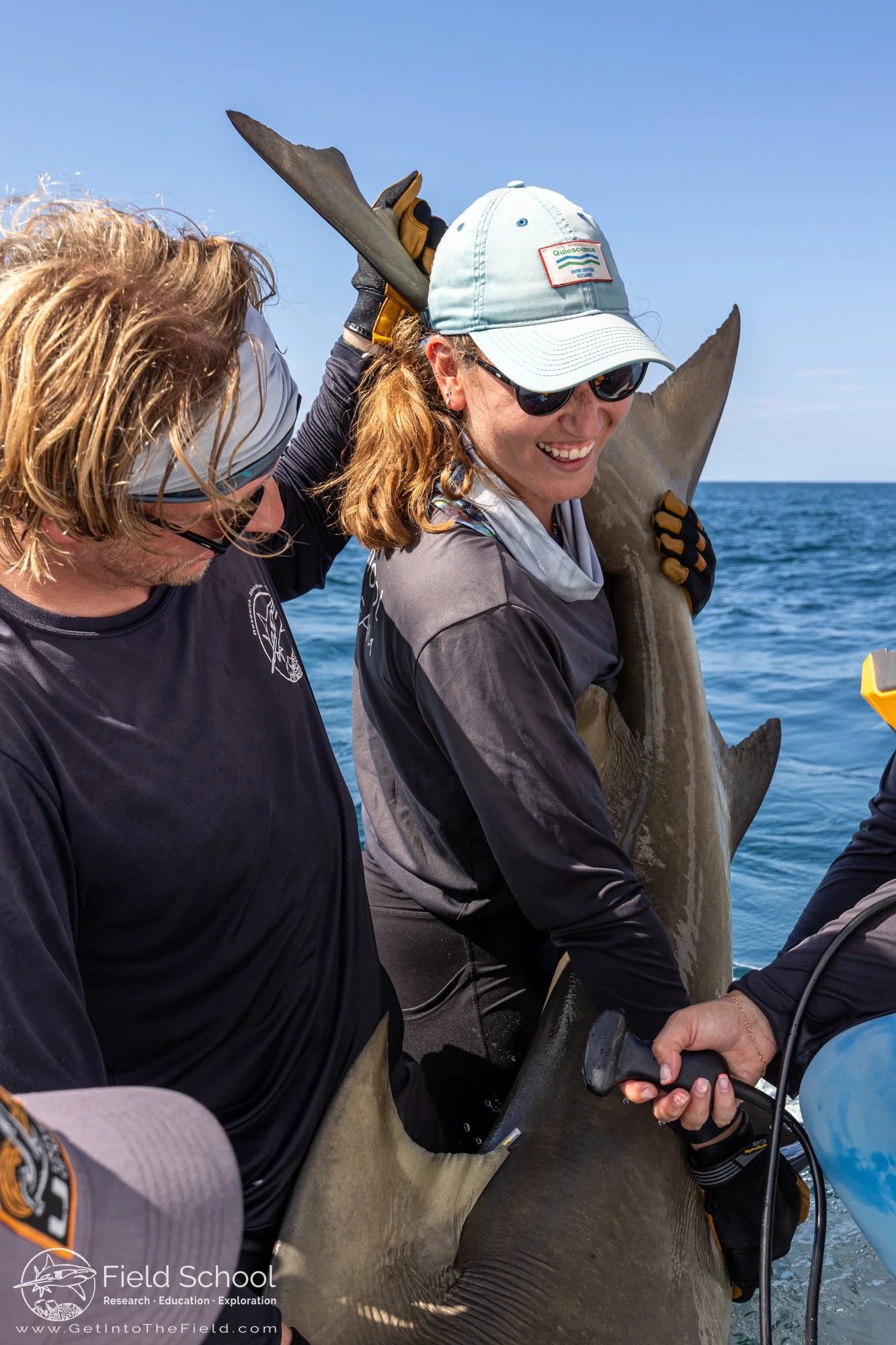Jake Jerome and Emma DeLillo preparing a lemon shark for a blood draw