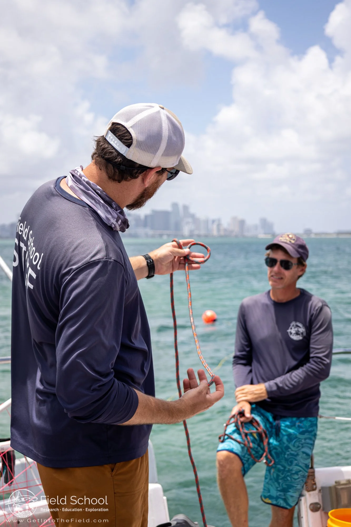 Captain Nick Pernis and Captain Christian Pankow teaching students how to tie bowline knots