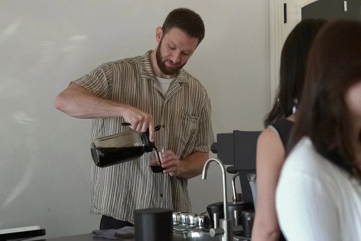 Owner James Giannitsis serving coffee beverages to his customers.