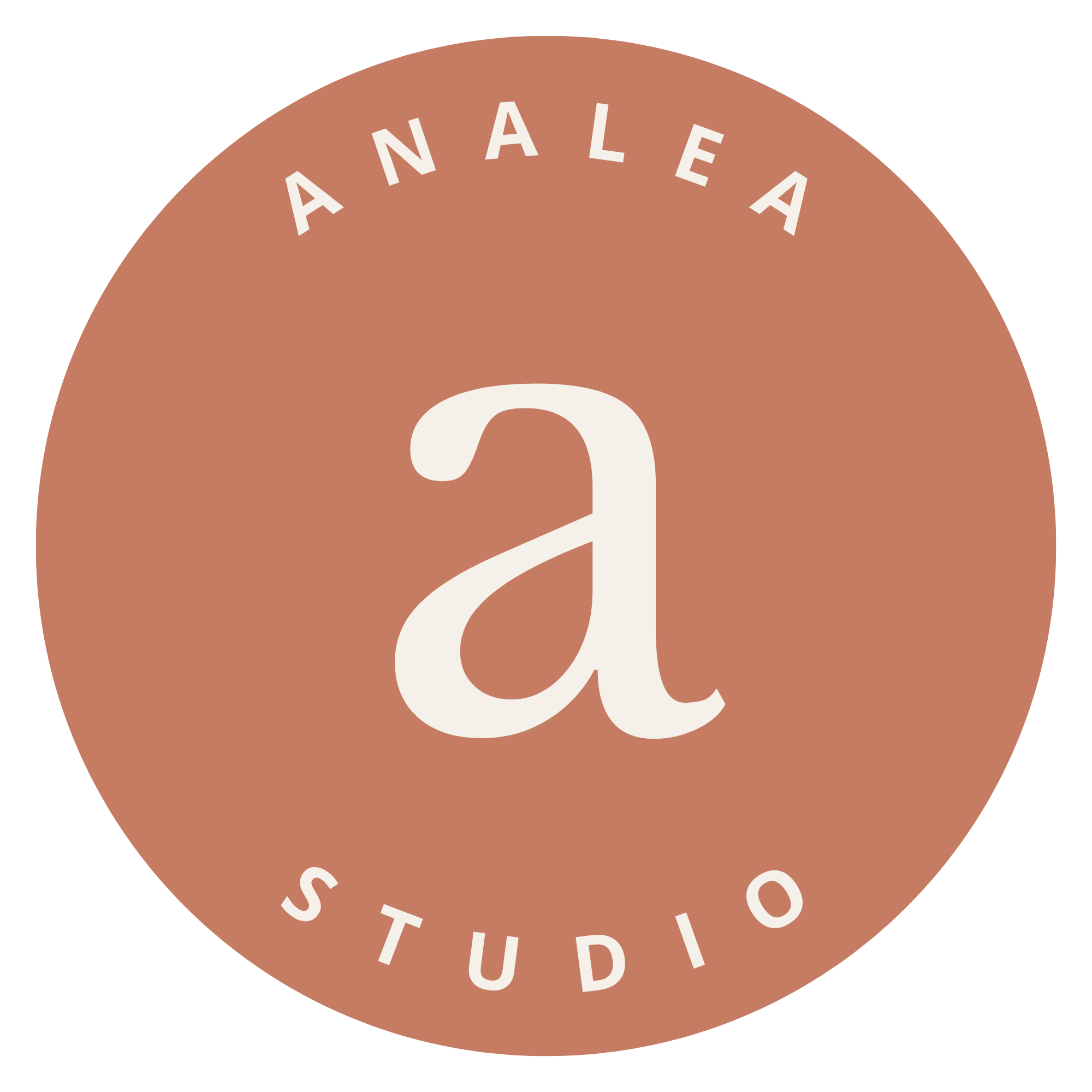 Close-up of a circular logo with a brown background, text reading 'ANALÉA' at the top and 'STUDIO' at the bottom, with a large curved letter 'a' in the center.