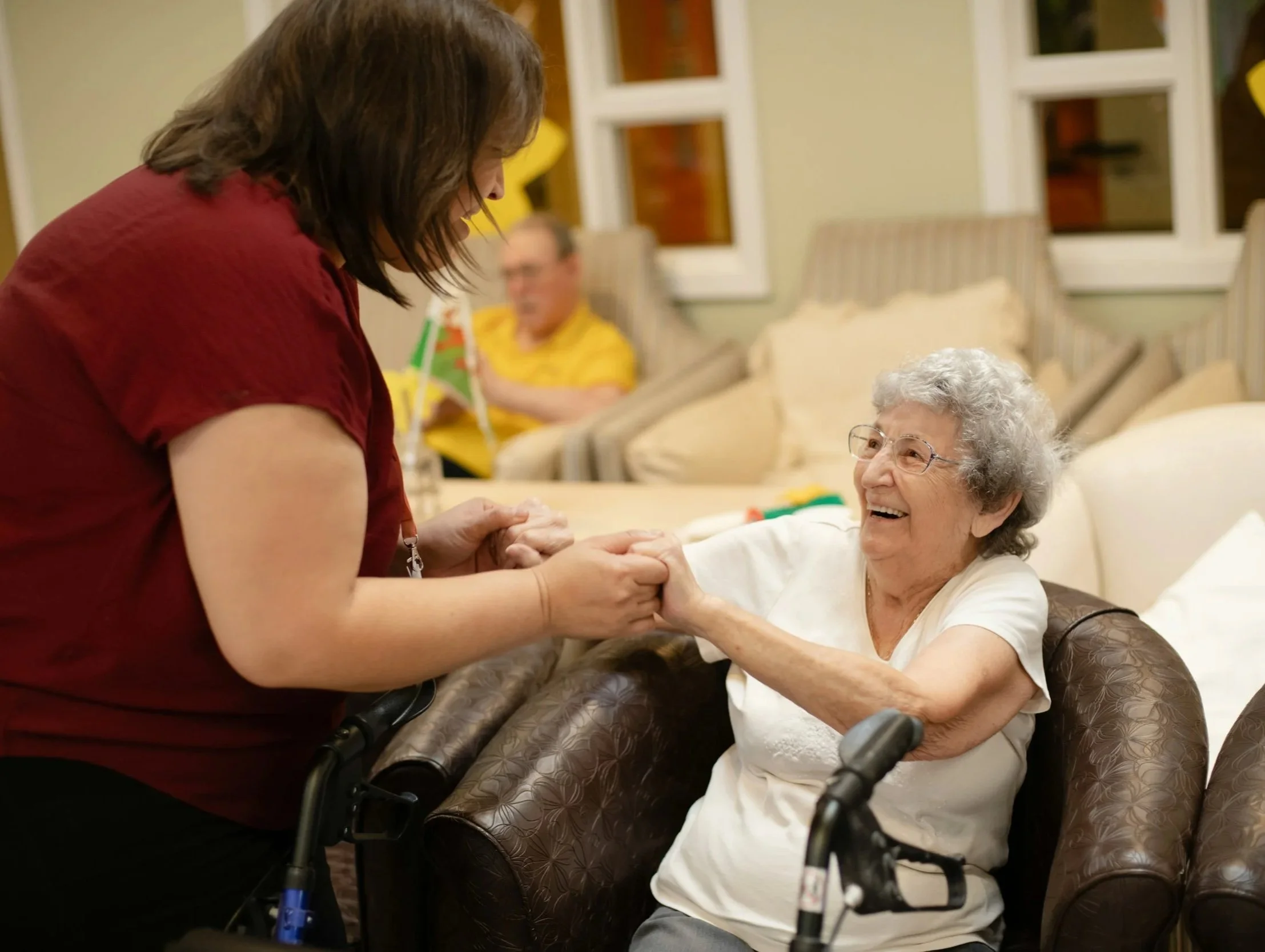 elderly woman being helped by care worker
