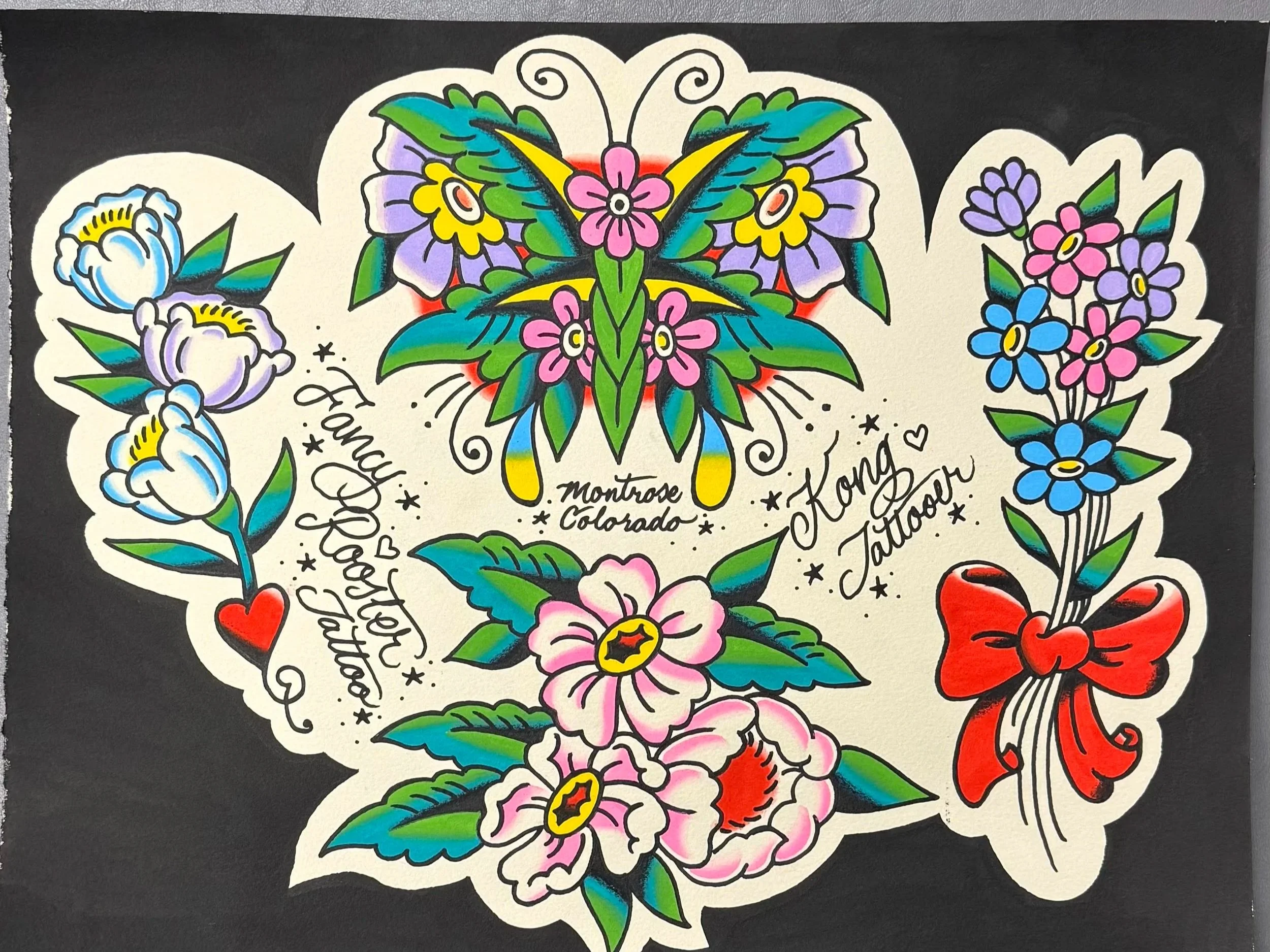 Colorful tattoo-style floral design with a butterfly at the center, surrounded by pink, purple, blue, and red flowers with green leaves, on a black background.
