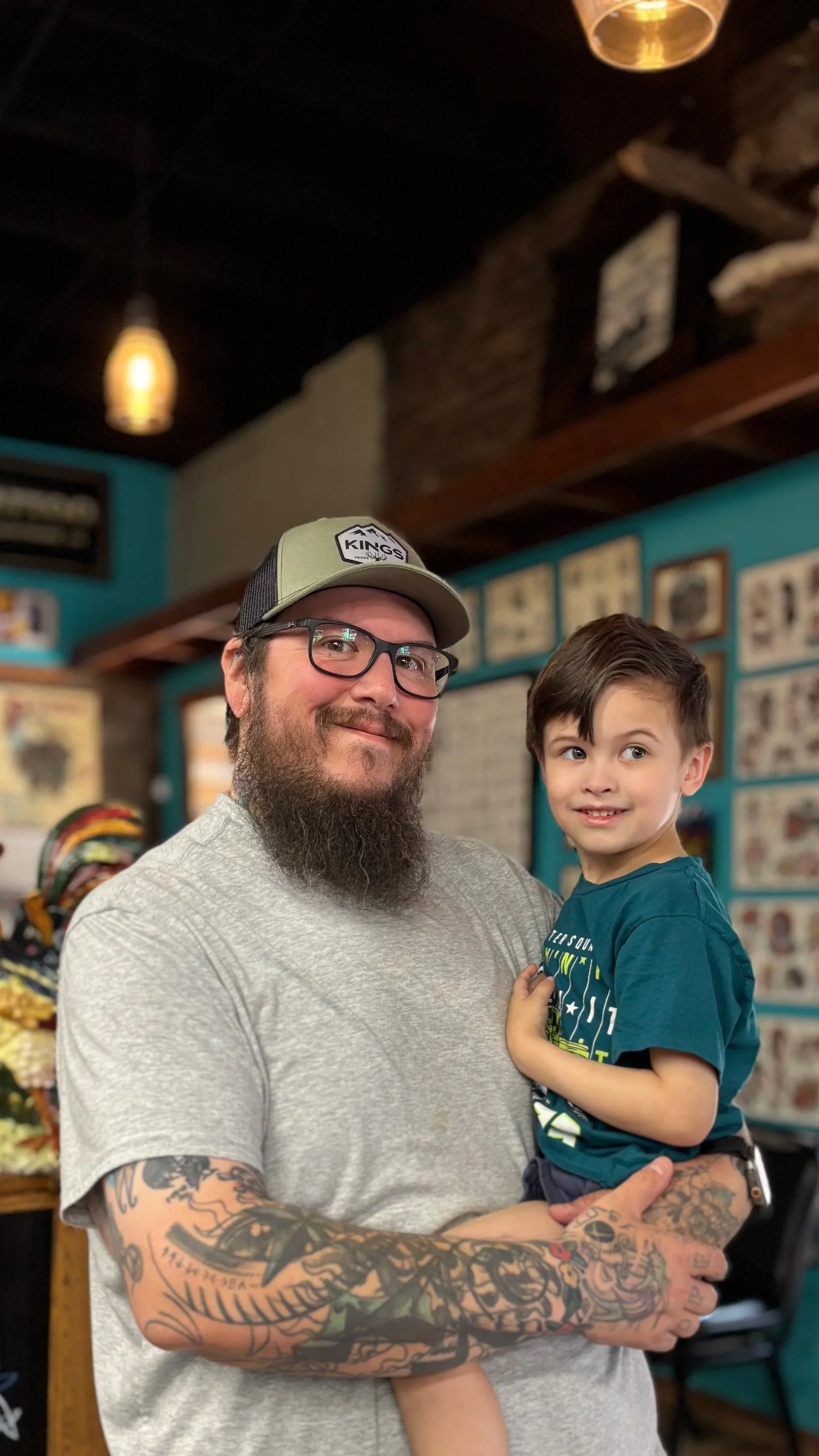 Kong Tattooer with nameless child, surely an actor hired to make him look more approachable and likeable. Definitely not his child.