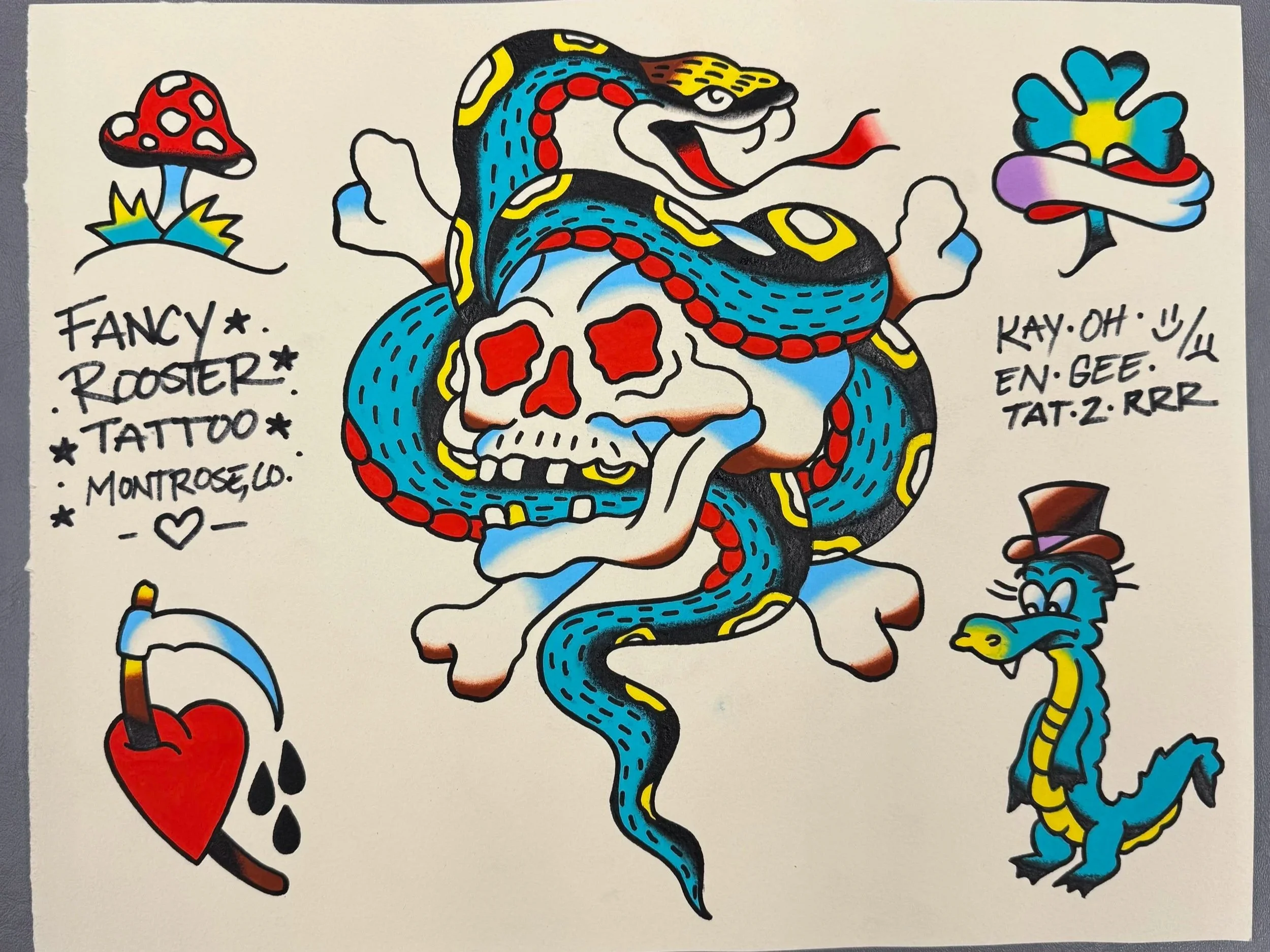Colorful tattoo art of a snake intertwined with a skull, with mushrooms, hearts, and a small face in the design, and handwritten notes around the image.