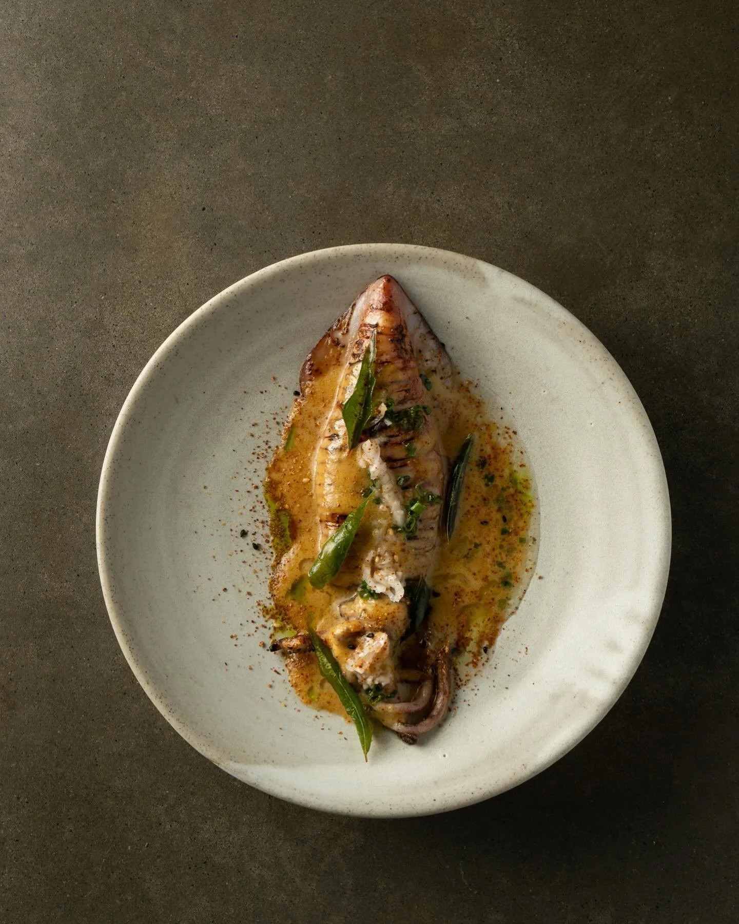 Local squid &ldquo;ichiya-boshi&rdquo;
Brown butter,confit garlic &amp; caramelised mustard sauce, fried curry leaves and Japanese seven spice &ldquo;Shichimi&rdquo;
Traditional Japanese preparation for squid is called &ldquo;Ichiya-boshi&rdquo; that