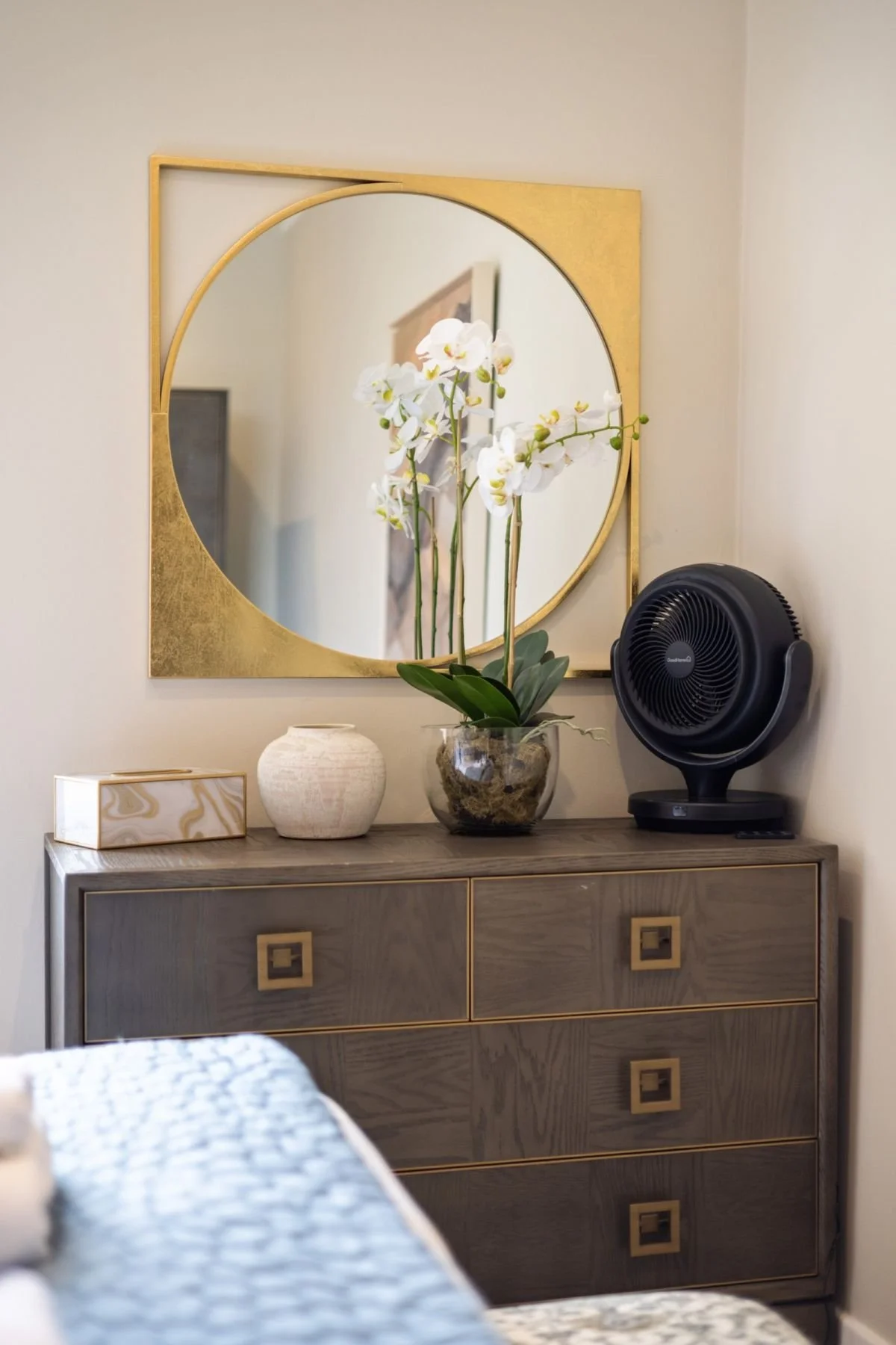 Dressing table with gold round mirror and orchid at West Regent Street, Glasgow, by SANNA Design Studio
