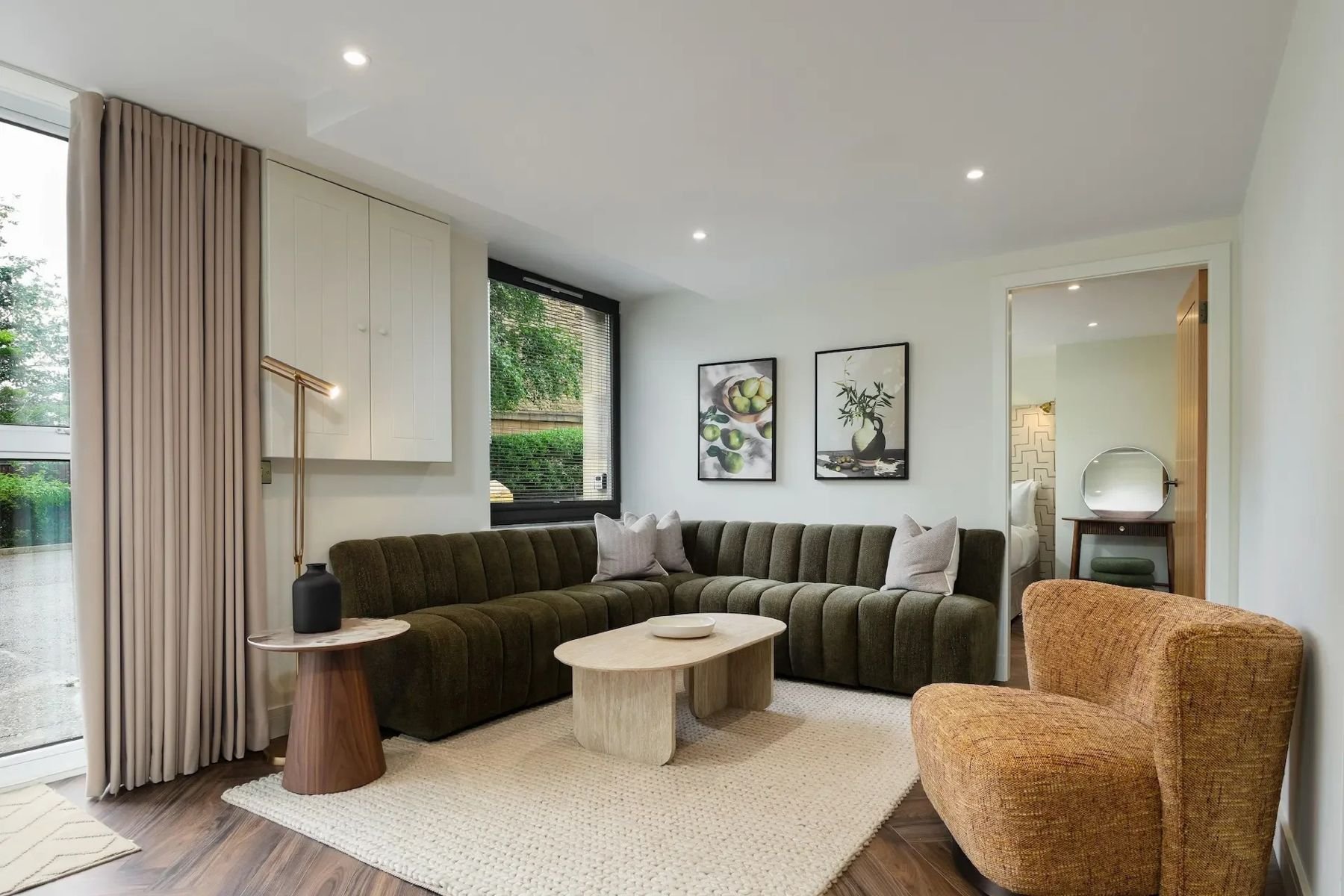 Living room at East London Street, Edinburgh, with olive velvet sofa, travertine coffee table and boucle armchair, furnished by SANNA Design Studio