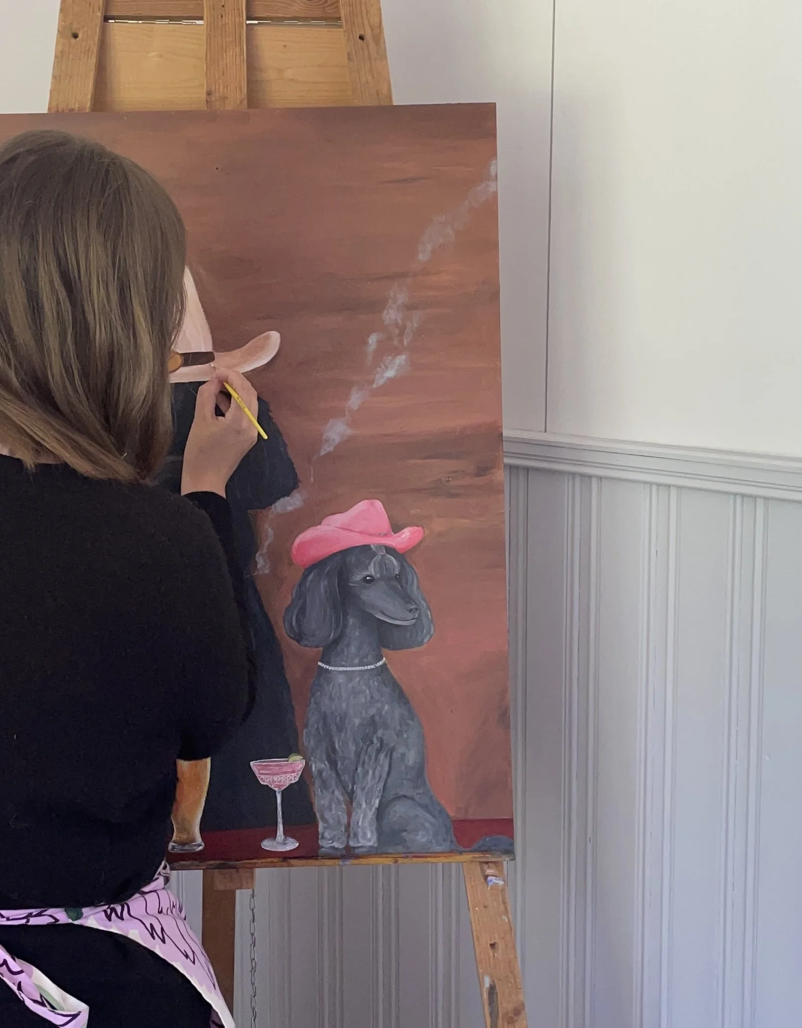 Charlotta painting a custom animal portrait in her home studio.