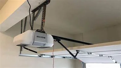 Garage ceiling with automatic garage door opener and tracks.