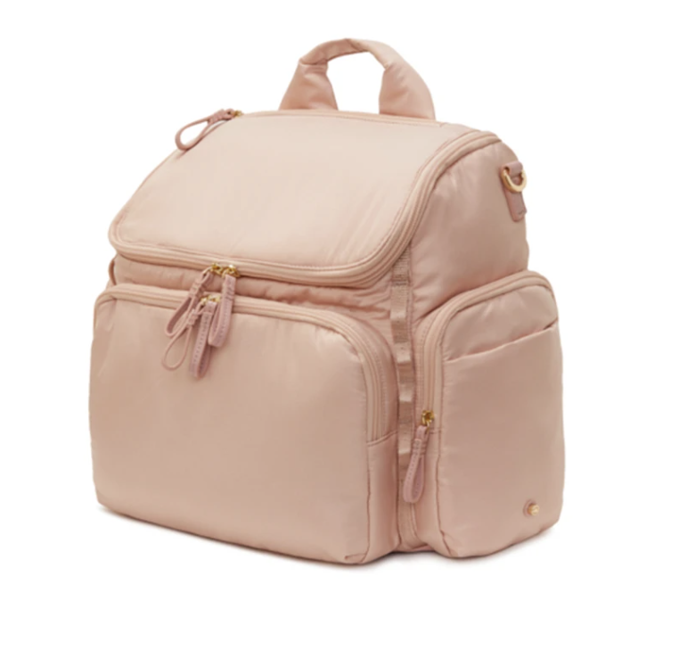 A light pink backpack with multiple zippered compartments and a top handle.